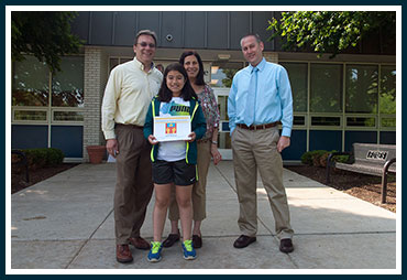 Ella with parents Mike and Jill and Principal Mike Rowe